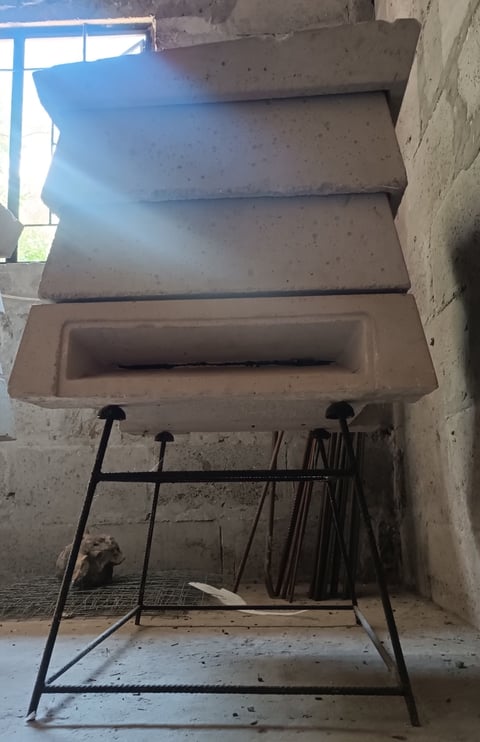 Concrete interior with shelving unit and metal storage rack containing various tools and supplies